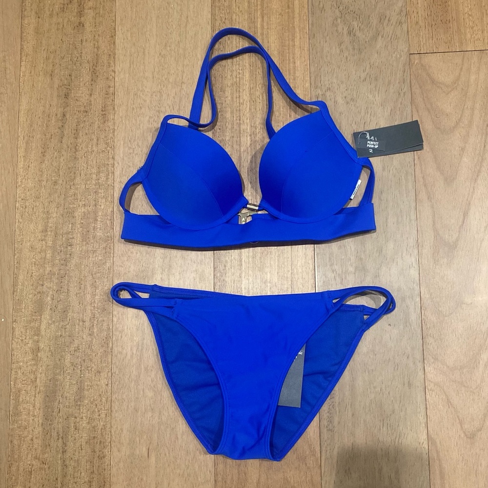 Blue bikini top and bottom. Never worn. 34 B. Small bottoms.